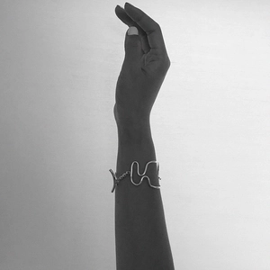 Elegant 925 sterling silver woven knot bracelet on model wrist with minimalist style