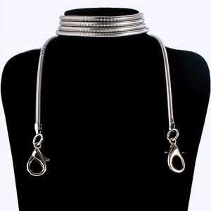 Close-up of silver snake bone chain with large lobster clasps on a black neck model