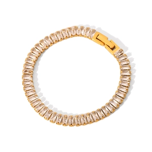 Macro detail of gold-plated tennis bracelet with rectangular zircons and folding clasp