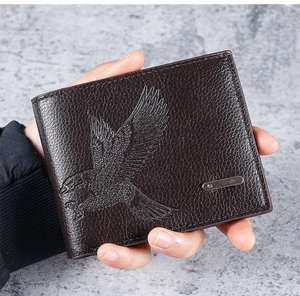 Macro shot of dark brown pebbled leather wallet featuring an embossed eagle motif