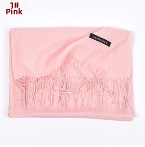 Detail of pink cashmere scarf featuring soft texture and elegant fringe tassels
