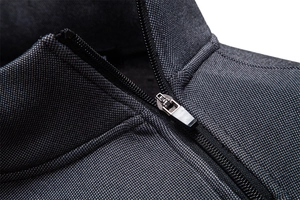 Macro shot of dark grey fleece-lined stand collar and durable metal zipper texture