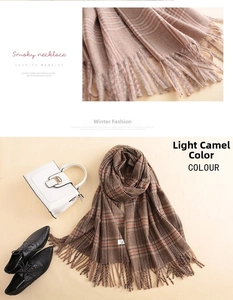 Detail of light camel plaid cashmere scarf with soft fringe and thick woven texture