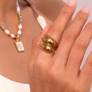 Detail of 18K gold-plated geometric ring worn on finger with smooth metallic finish