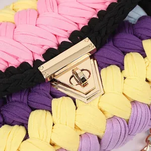 Handmade crochet square bag with colorful fabric strips and golden metal lock