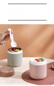 Macro detail of portable stainless steel soup cups with folding spoons and handles