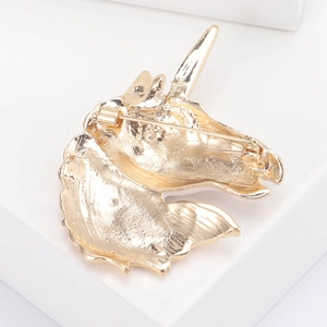 Detailed back view of a golden unicorn brooch showing the pin and secure clasp mechanism