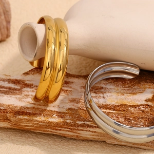Dettaglio di bracciali rigidi a doppio strato in oro 18K e argento su pietra naturale