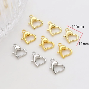 Close-up of gold and silver heart-shaped lobster clasps with size dimensions for jewelry