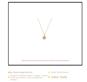 Detail of pink cat-eye stone flower pendant with red zircon on gold titanium steel chain