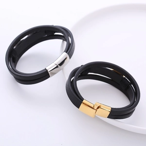 Detail of multi-layer leather bracelets with gold and silver magnetic metal clasps