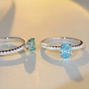 Macro shot of silver ring featuring oval blue stone and pavé-set shimmering zircon details