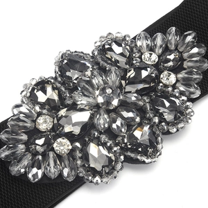 Elastic waist belt for dresses featuring a large dark grey crystal flower buckle