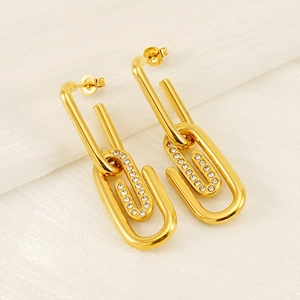 Detailed close-up of gold paperclip drop earrings with sparkling pavé cubic zirconia