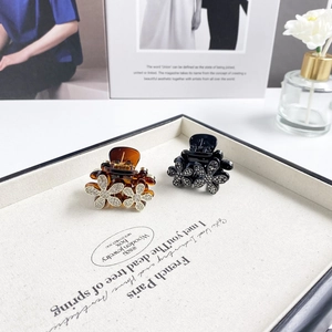 Detailed view of floral hair clips with rhinestones in tortoise and black finish