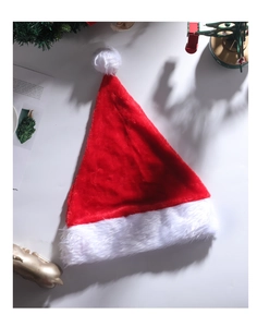 Detail view of plush red Christmas hat with soft white pompom and festive LED lighting