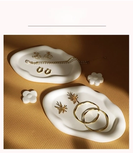 Macro shot of gold jewelry collection with pearls on white plaster display stands