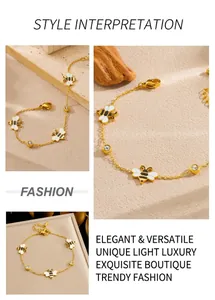 Detail of gold-plated chain bracelet with enamel bees and white zircon inlays