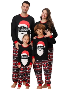 Close-up of family Christmas pajamas with Believe Santa print and Nordic snowflake pattern