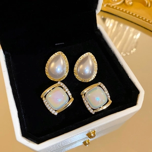 Vintage teardrop pearl and square rhinestone stud earrings in a luxury jewelry box
