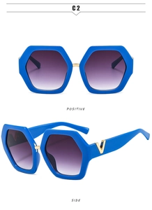 Macro detail of blue hexagonal sunglasses featuring golden V-logo decoration on the side