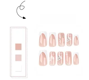 Detail of pink French press-on nails with glitter butterfly and rhinestone accents