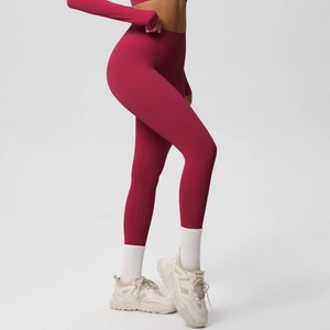 Detailed side view of dark red high waist yoga leggings and long sleeve sports crop top