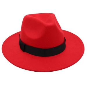 Close-up of a vibrant red fedora hat with a classic black ribbon and wide flat brim