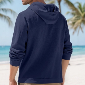 Men's navy cotton linen hooded shirt jacket in a relaxed fit with beach background