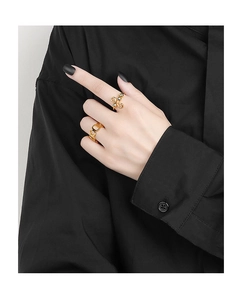 Close-up of golden beaded fidget rings and hollow chain link design on model fingers