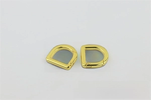 Close-up of golden D-ring spring buckles for handbags with high-gloss electroplating finish