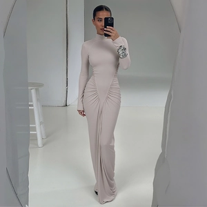 Detailed close-up of high neck beige long sleeve maxi dress with elegant ruched waist design