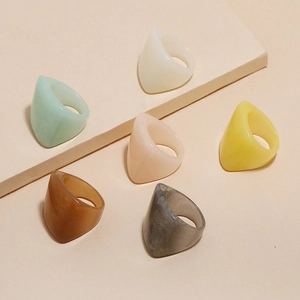 Detailed arrangement of colorful geometric resin rings in various pastel and earth tones