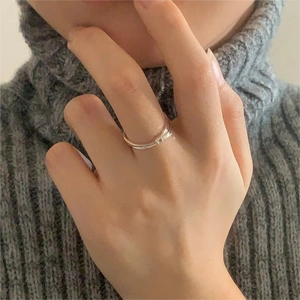 Close-up of minimalist S925 sterling silver bamboo joint ring worn on a finger