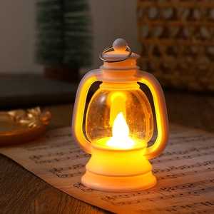 Close-up of a white vintage LED lantern placed on sheet music with warm glowing light