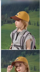 Outdoor lifestyle view of kids' yellow and brown baseball cap with GOOD embroidery
