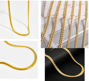 Detail of golden flat curb chain necklace with leaf-like texture and embossed metal finish