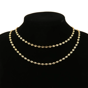 Elegant 18k gold coffee bean pig nose chain necklace on a black velvet neck bust display