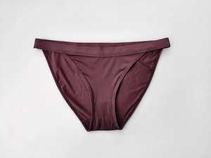 Flat lay view of sexy low-waist burgundy ice silk panties with breathable cotton crotch