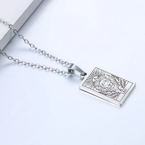Macro shot of silver Leo zodiac rectangular pendant with engraving on stainless steel