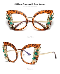 Detail of tortoiseshell cat eye glasses with emerald rhinestones and gold leaf accents