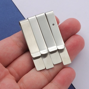 Macro shot of stainless steel money clips with brushed and polished finishes