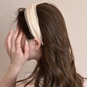 Elegant beige silk headband with minimalist silver earrings and pearl ring on model