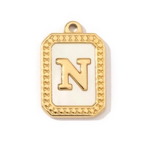 Detailed view of vintage gold plated stainless steel N letter pendant with shell inlay