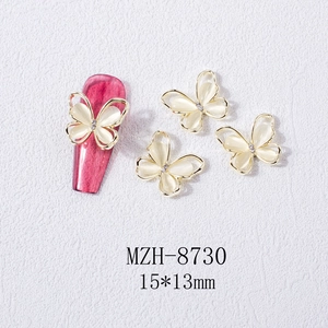 Detail of 15x13mm gold butterfly nail art charms with opal stone and diamond inlay
