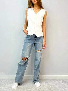 Women's summer white sleeveless V-neck vest cardigan paired with distressed blue jeans