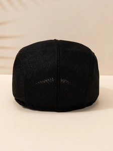 Close-up of black breathable linen beret showing intricate woven texture and summer style