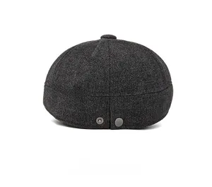 Rear view of dark grey wool blend brimless cap featuring silver metal adjustable buckles