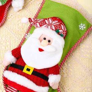 Detail of green Christmas stocking with 3D Santa Claus and snowflake embroidery patterns