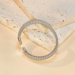 Silver woven mesh open cuff bracelet in stainless steel on a natural stone base
